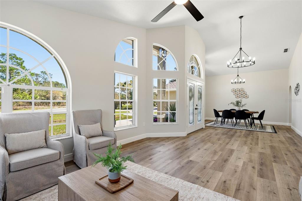10185 Sleepy Willow Court Spring Hill, FL 34608 - Photo 8 of 44 a living room with furniture and a large window