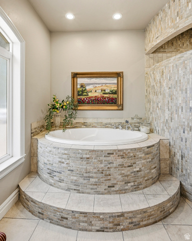 2204 Bridgewater Road Cedar City, UT 84721 - Photo 15 of 40 Luxurious Recessed Soaking Tub with Stone Tile Surround and Tiered Entry Steps for Ultimate Relaxation