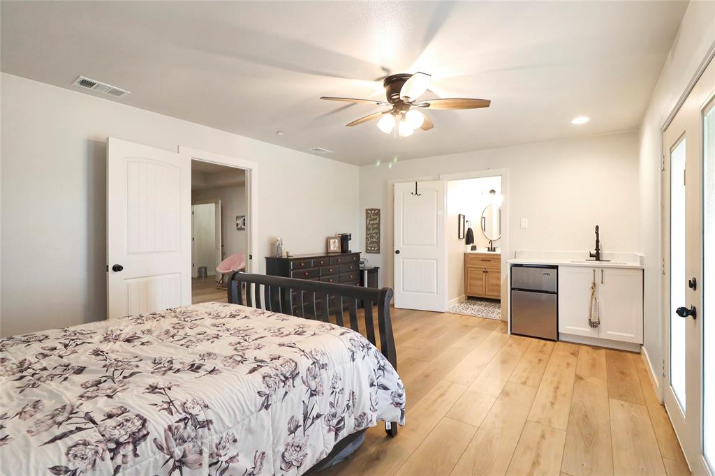 2408 Strader Road DISH, TX 76247 - Photo 24 of 40 a bed room with a bed and a chandelier