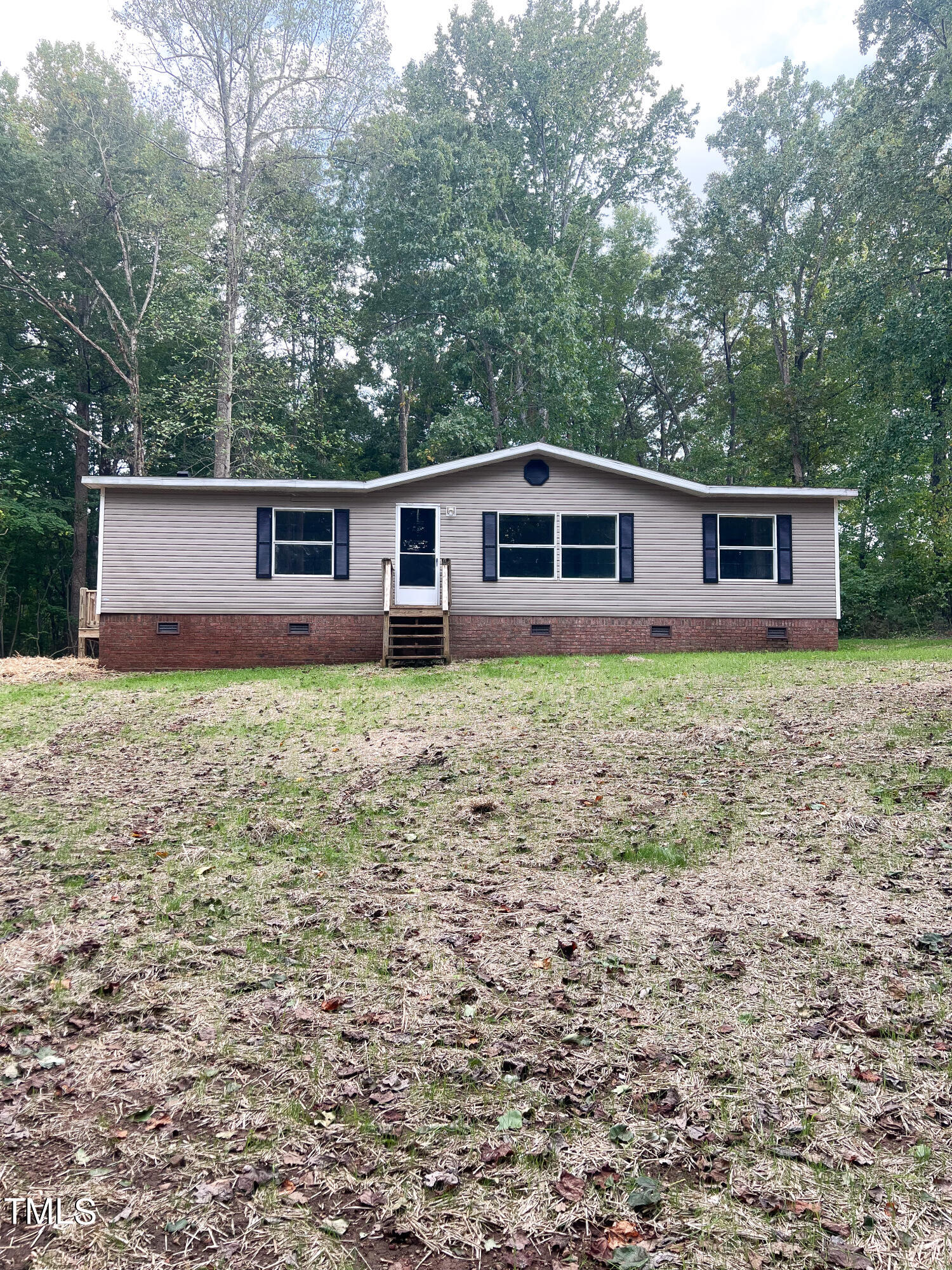 364 Moody Loop Road Siler City, NC 27344 - Photo 1 of 20 a front view of house with yard and trees all around