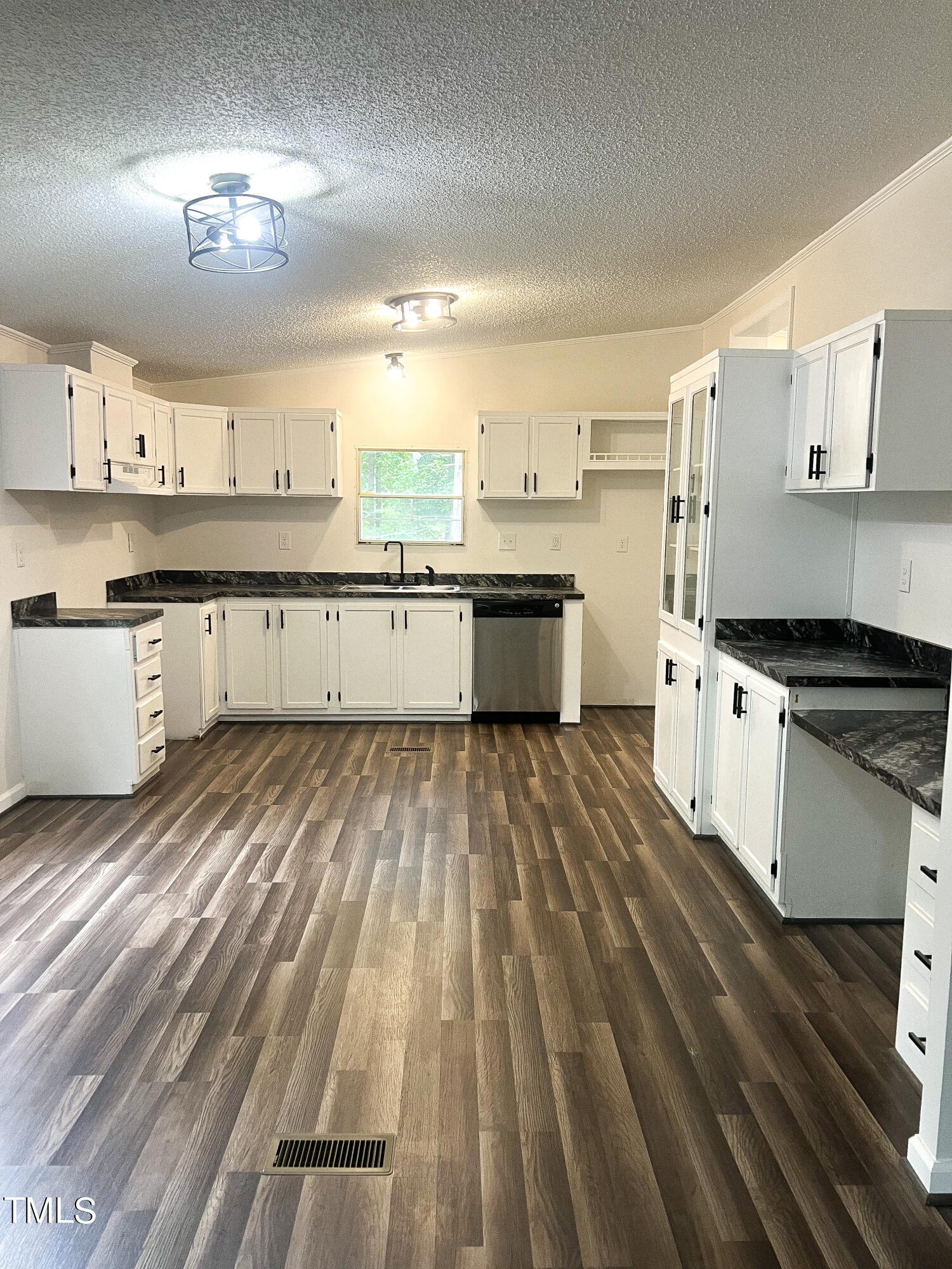 364 Moody Loop Road Siler City, NC 27344 - Photo 3 of 20 a large kitchen with granite countertop a stove top oven a sink a counter space and cabinets