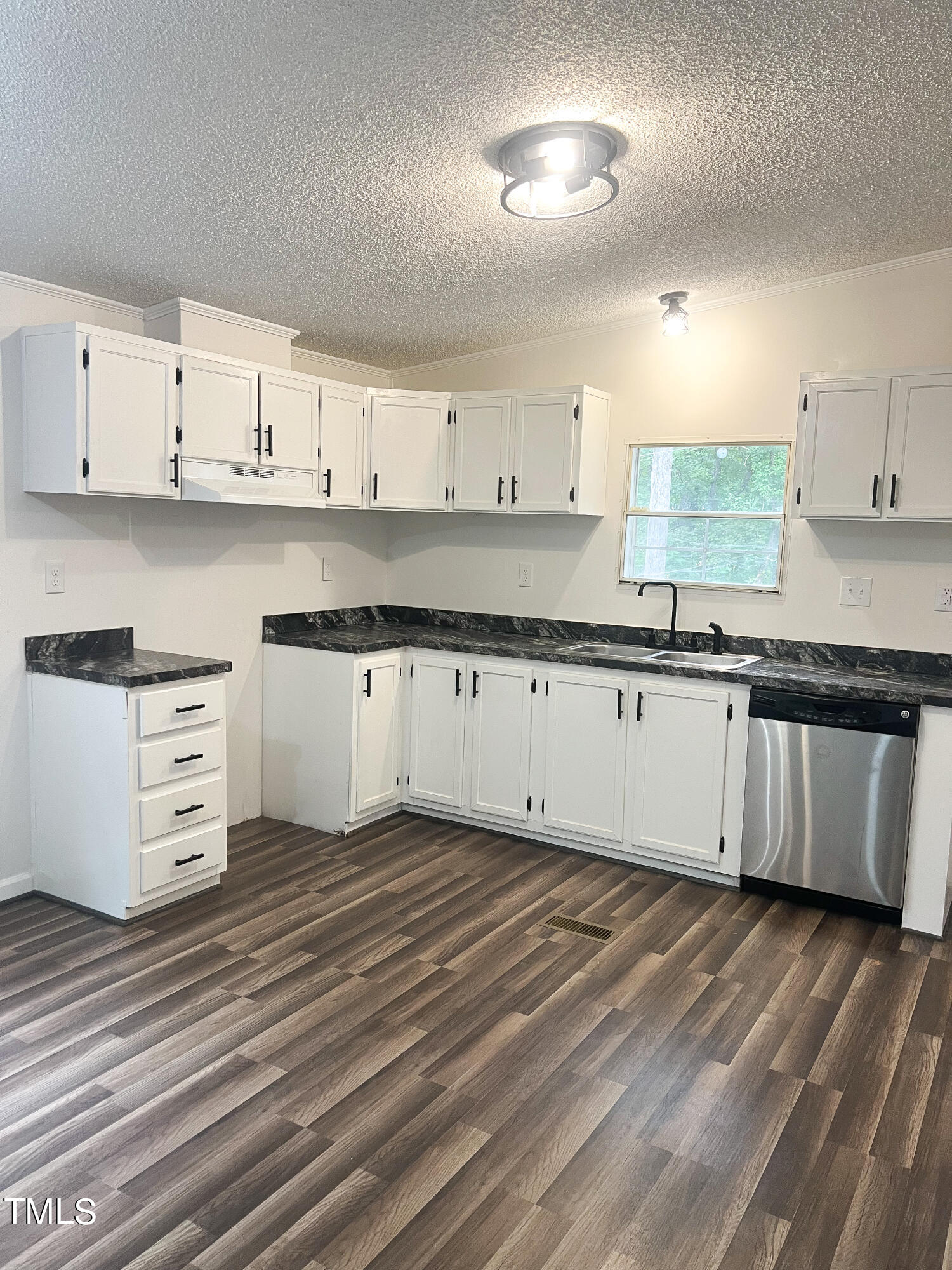 364 Moody Loop Road Siler City, NC 27344 - Photo 5 of 20 a kitchen with granite countertop a white stove top oven and white cabinets