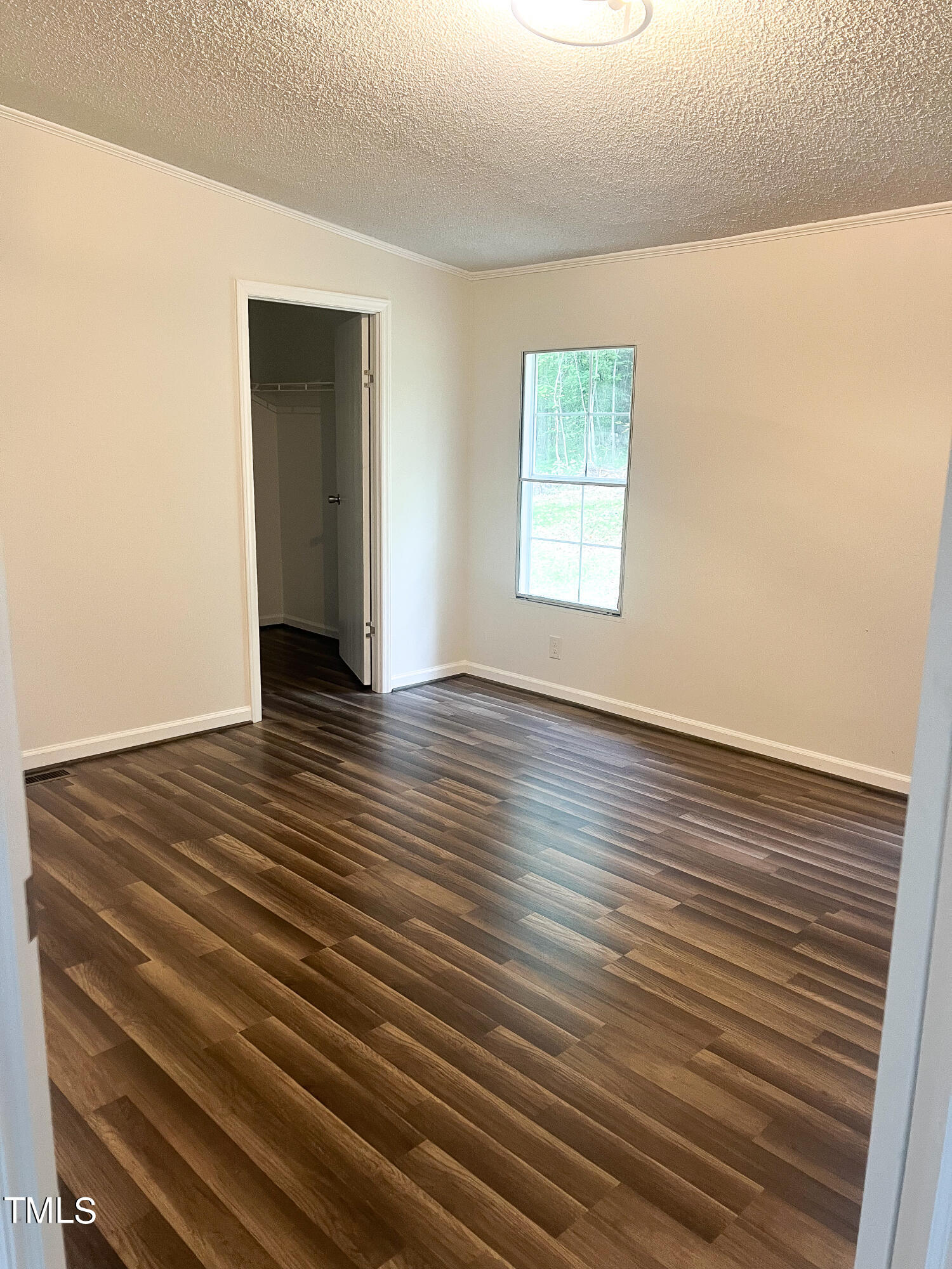 364 Moody Loop Road Siler City, NC 27344 - Photo 10 of 20 a view of an empty room with wooden floor and a window