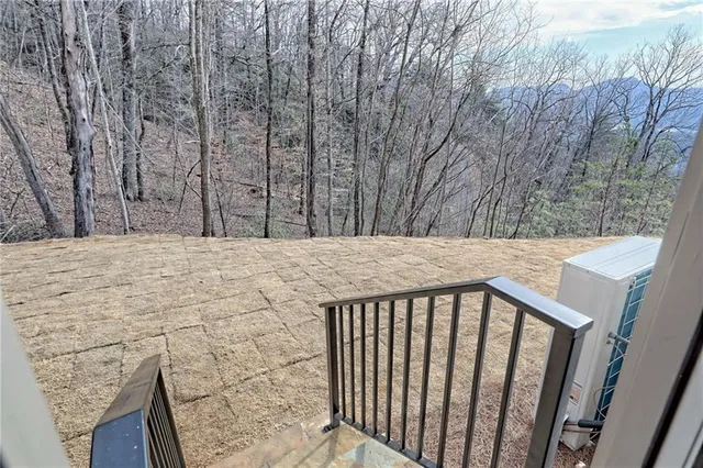 a view of staircase with wooden floor and a chandelier