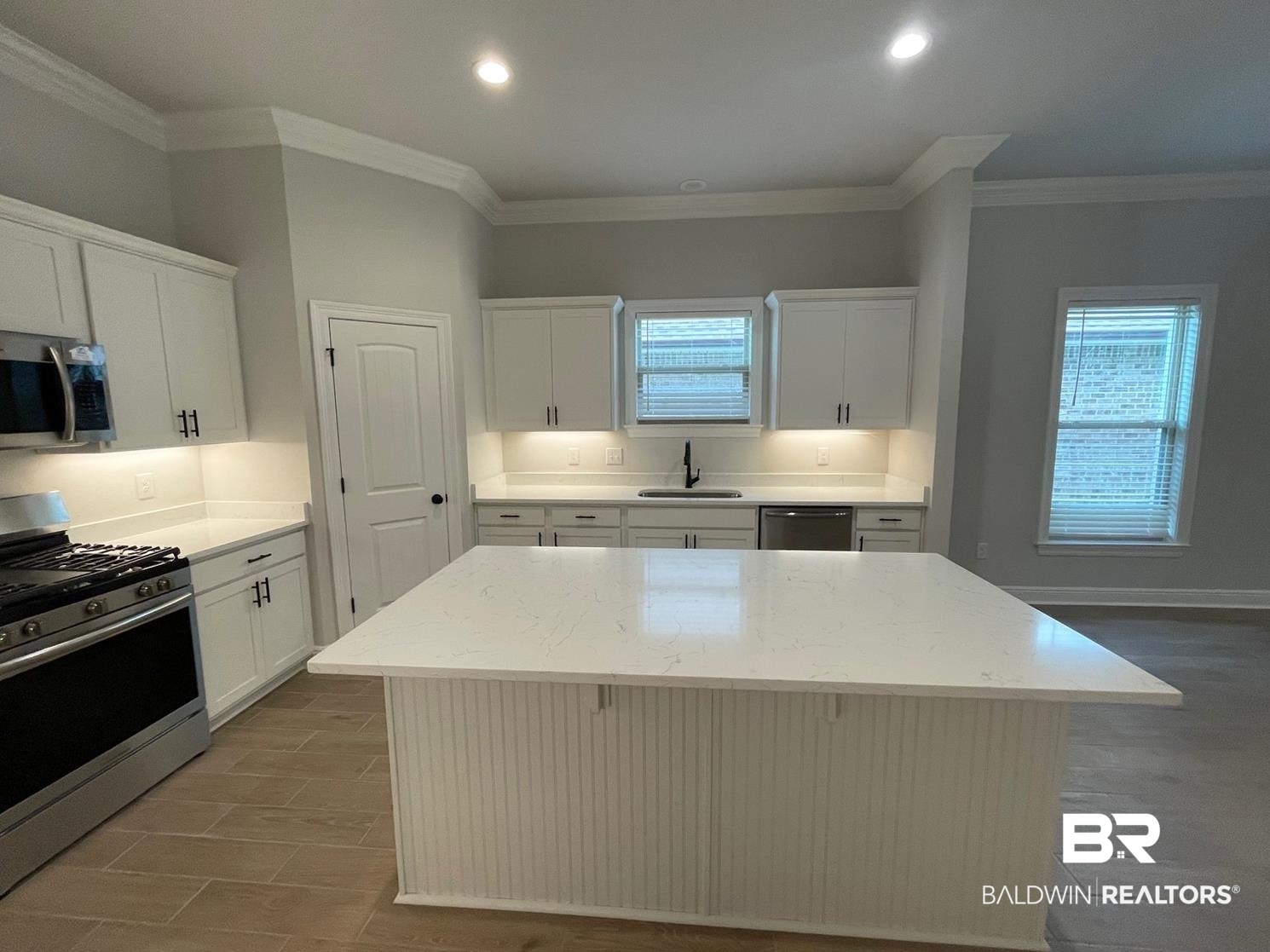 1626 Fenton Circle Foley, AL 36535 - Photo 2 of 16 Kitchen featuring appliances with stainless steel finishes, a center island, a healthy amount of sunlight, and sink
