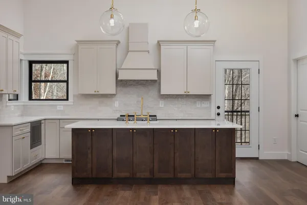 a kitchen with white cabinets and appliances