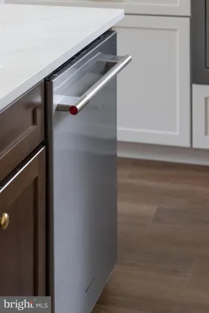 an empty room with wooden floor & closet area