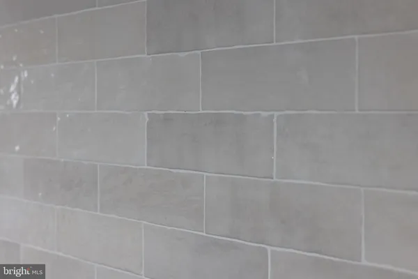 a bathroom with a granite countertop sink a mirror and a shower
