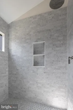 a view of empty room with wooden floor and window