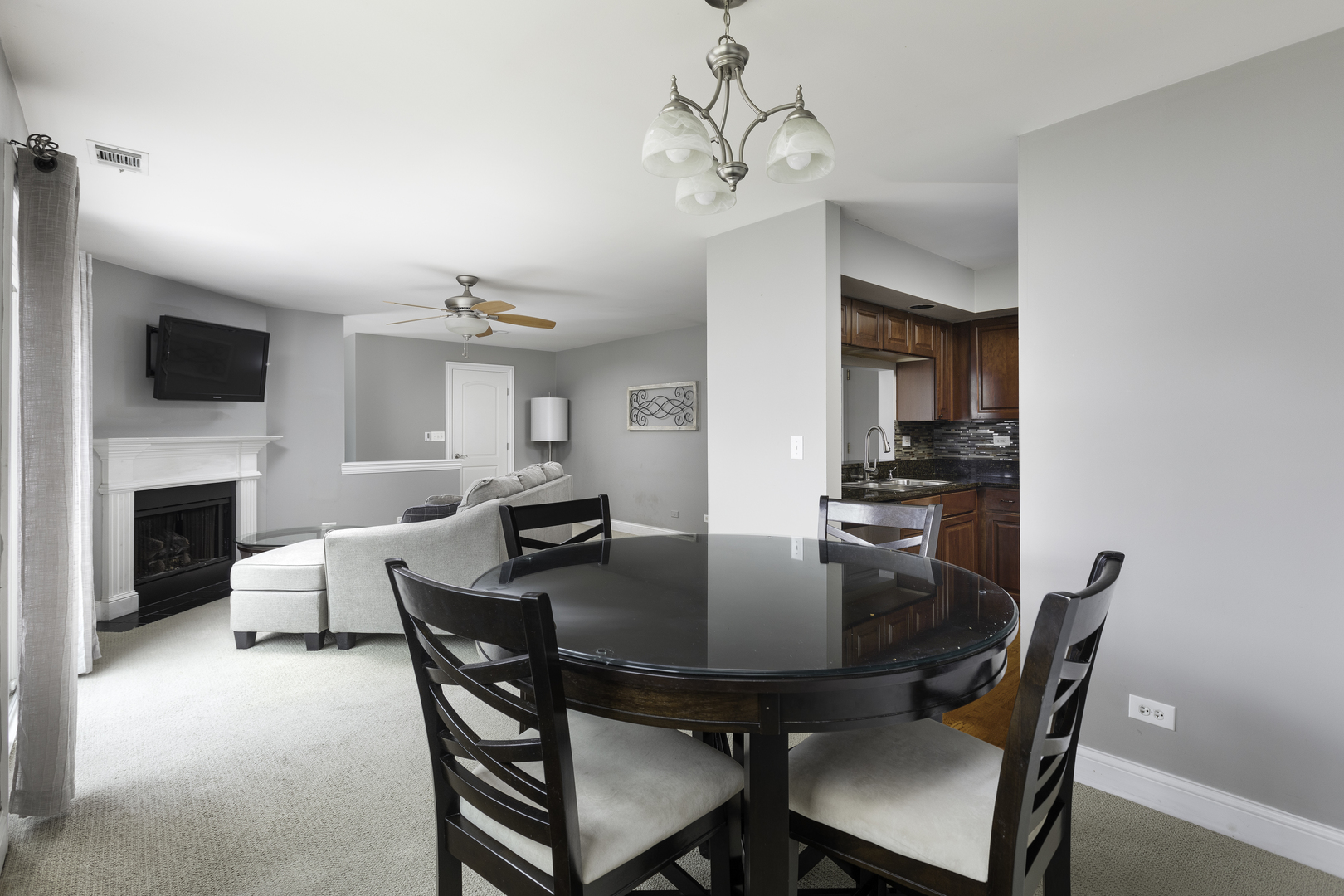 19 Foxcroft Road, Unit 203 Naperville, IL 60565 - Photo 11 of 29 a view of a dining room with furniture and a fireplace