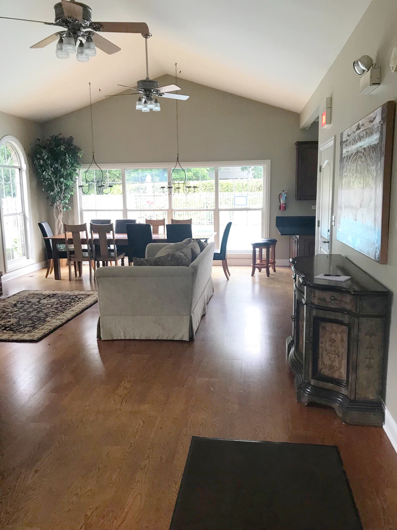 19 Foxcroft Road, Unit 203 Naperville, IL 60565 - Photo 25 of 29 a living room with furniture a flat screen tv and a large window
