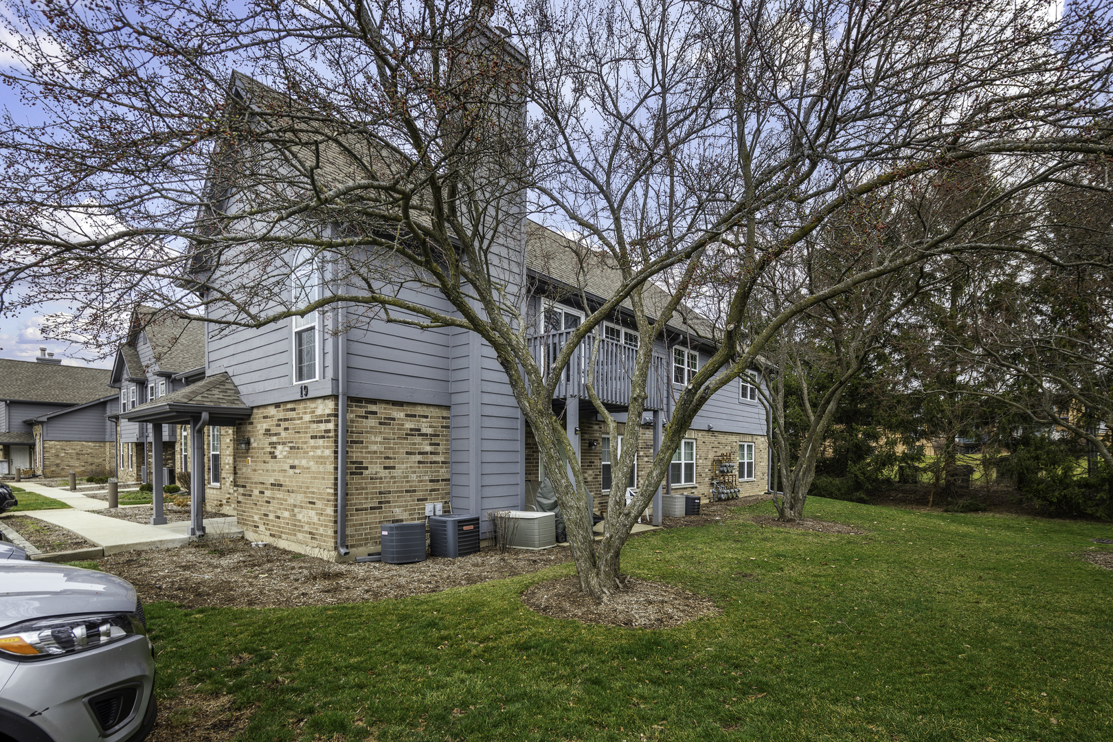 19 Foxcroft Road, Unit 203 Naperville, IL 60565 - Photo 29 of 29 front view of a house with a yard