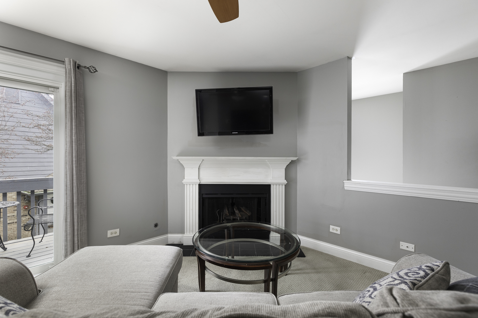 19 Foxcroft Road, Unit 203 Naperville, IL 60565 - Photo 7 of 29 a living room with furniture a flat screen tv and a fireplace