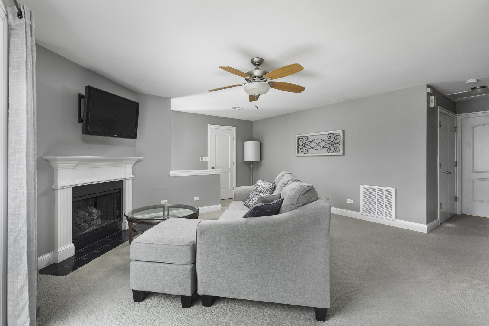 19 Foxcroft Road, Unit 203 Naperville, IL 60565 - Photo 9 of 29 a living room with furniture a flat screen tv and a fireplace