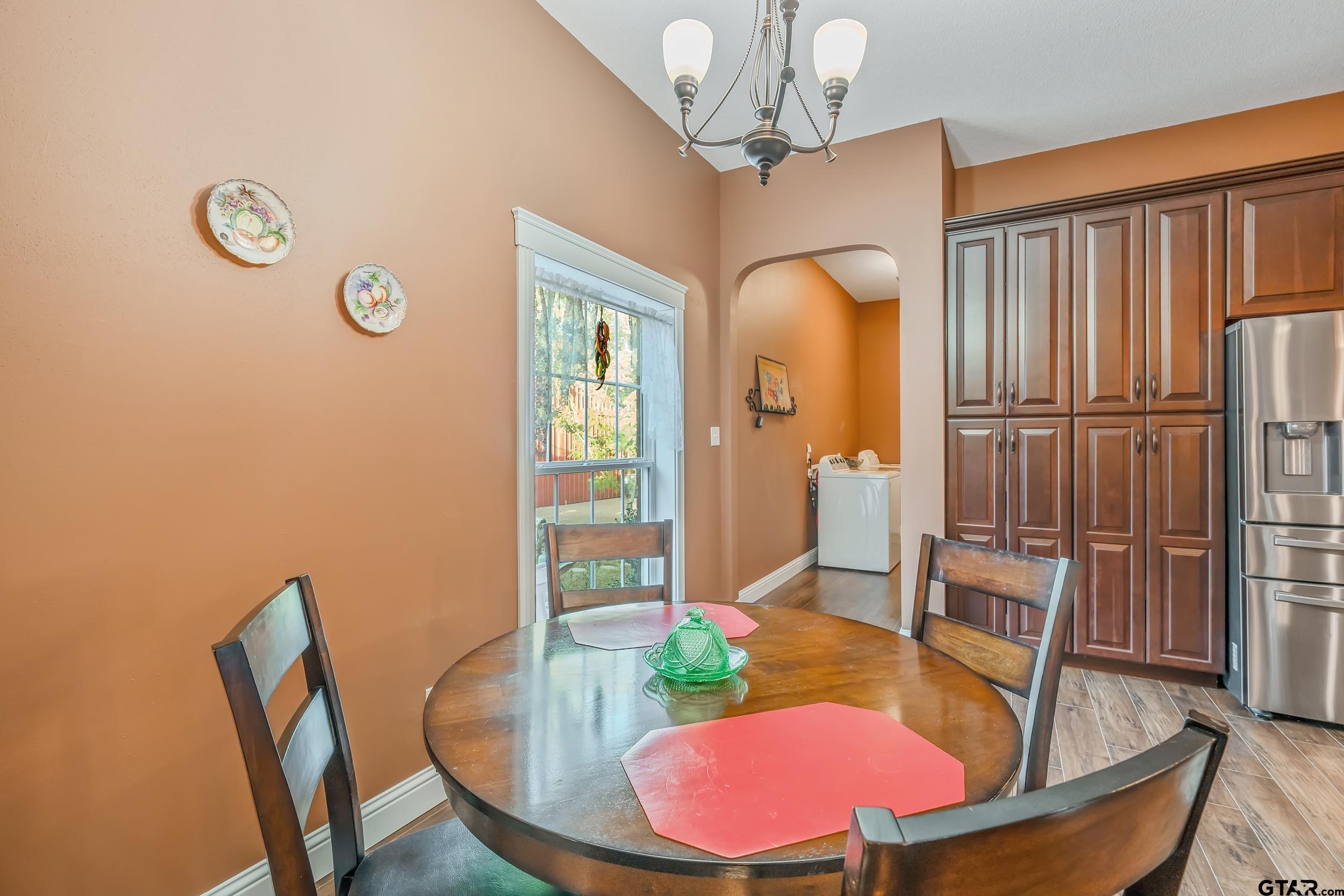 14375 County Road 384 Tyler, TX 75708 - Photo 29 of 48 a view of a dining room with furniture a chandelier and wooden floor