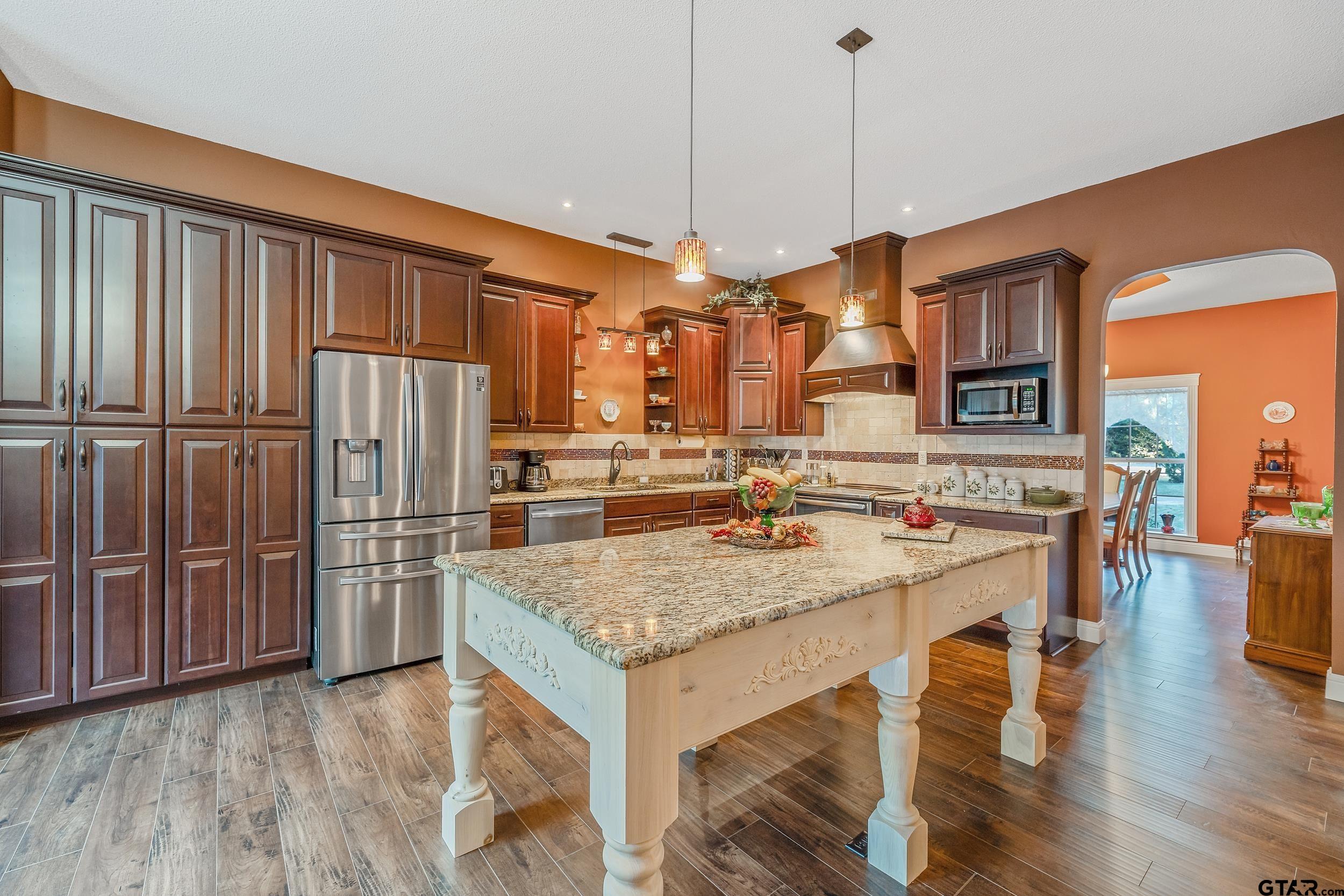 14375 County Road 384 Tyler, TX 75708 - Photo 30 of 48 a kitchen with stainless steel appliances granite countertop a refrigerator a stove and a sink