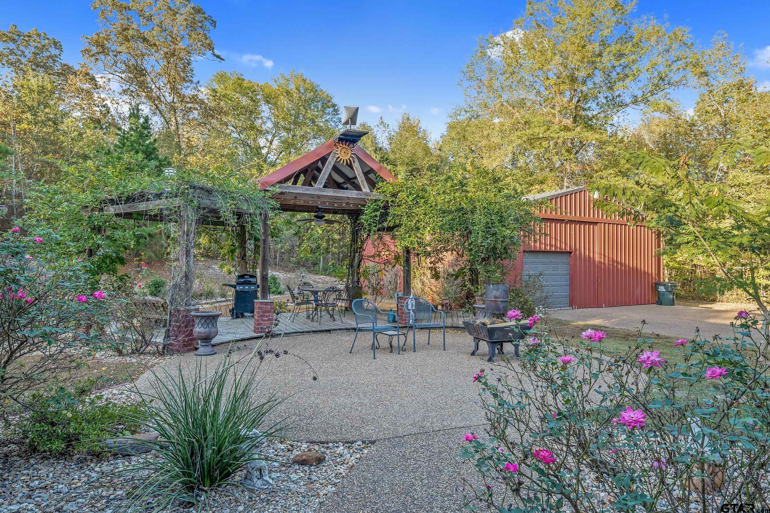 14375 County Road 384 Tyler, TX 75708 - Photo 35 of 48 a backyard of a house with table and chairs