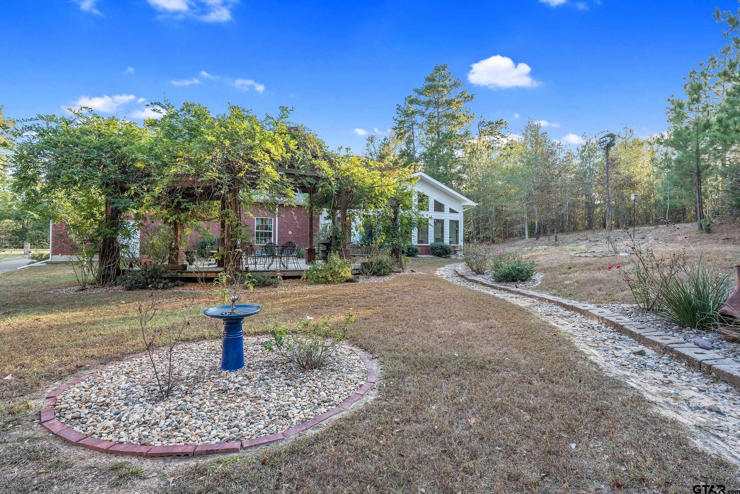 14375 County Road 384 Tyler, TX 75708 - Photo 36 of 48 a view of a fire pit in front of a house