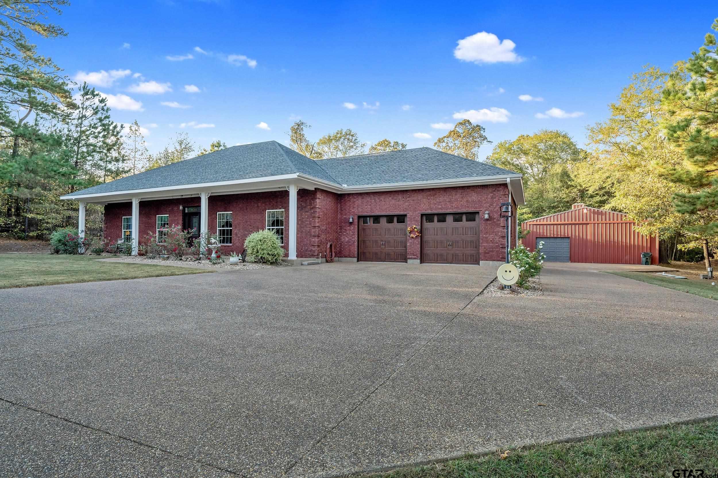 14375 County Road 384 Tyler, TX 75708 - Photo 40 of 48 a front view of a house with a yard and garage