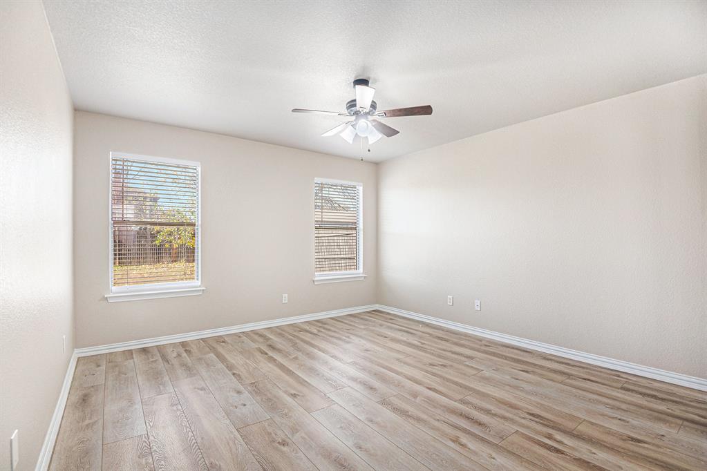 8313 Water Buck Run Fort Worth, TX 76179 - Photo 14 of 25 wooden floor in an empty room with a window