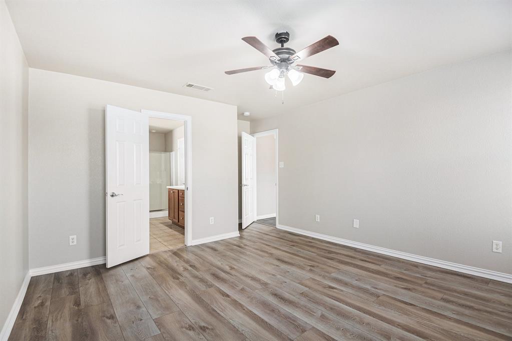 8313 Water Buck Run Fort Worth, TX 76179 - Photo 15 of 25 an empty room with wooden floor and mirror