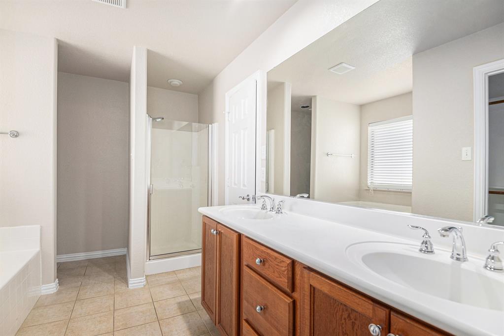8313 Water Buck Run Fort Worth, TX 76179 - Photo 16 of 25 a spacious bathroom with a double vanity sink mirror and