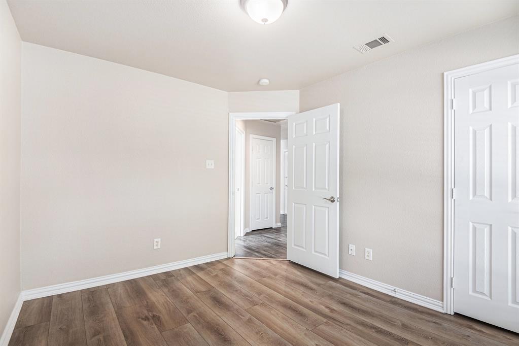8313 Water Buck Run Fort Worth, TX 76179 - Photo 19 of 25 a view of an empty room with wooden floor