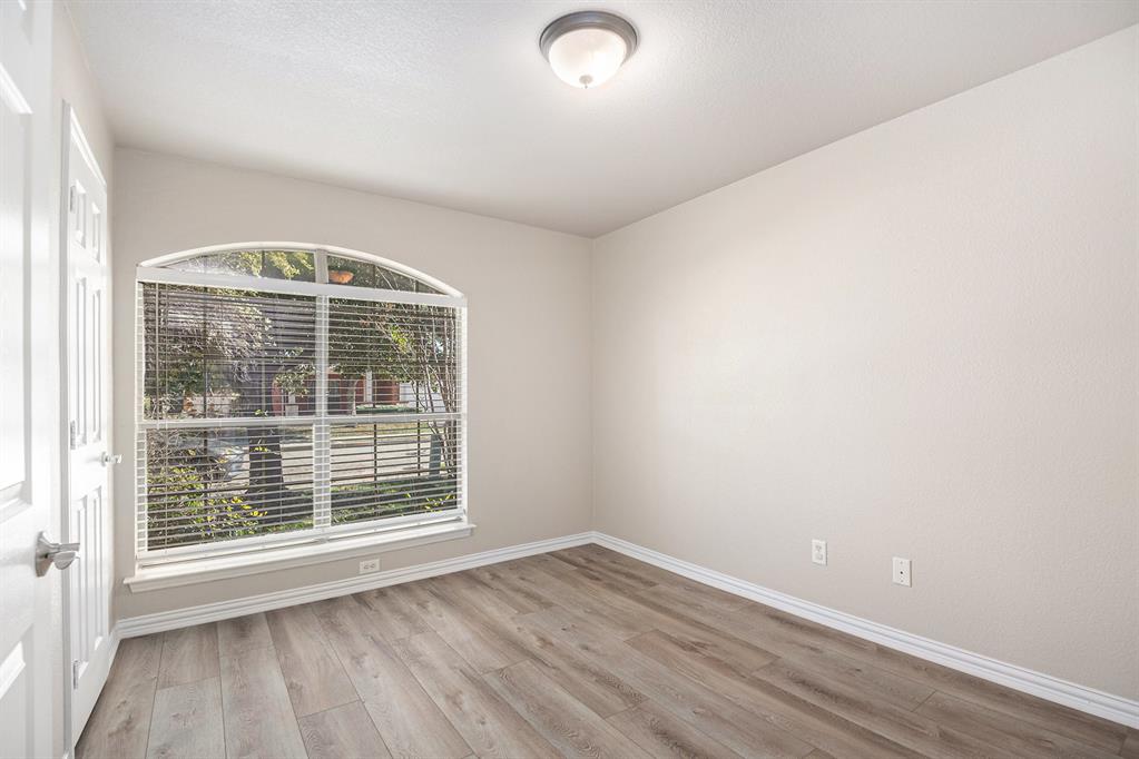 8313 Water Buck Run Fort Worth, TX 76179 - Photo 20 of 25 an empty room with wooden floor and windows