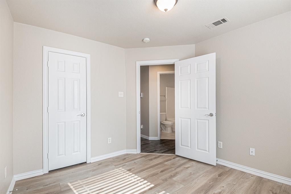 8313 Water Buck Run Fort Worth, TX 76179 - Photo 2 of 25 a view of a room with wooden floor and bathroom