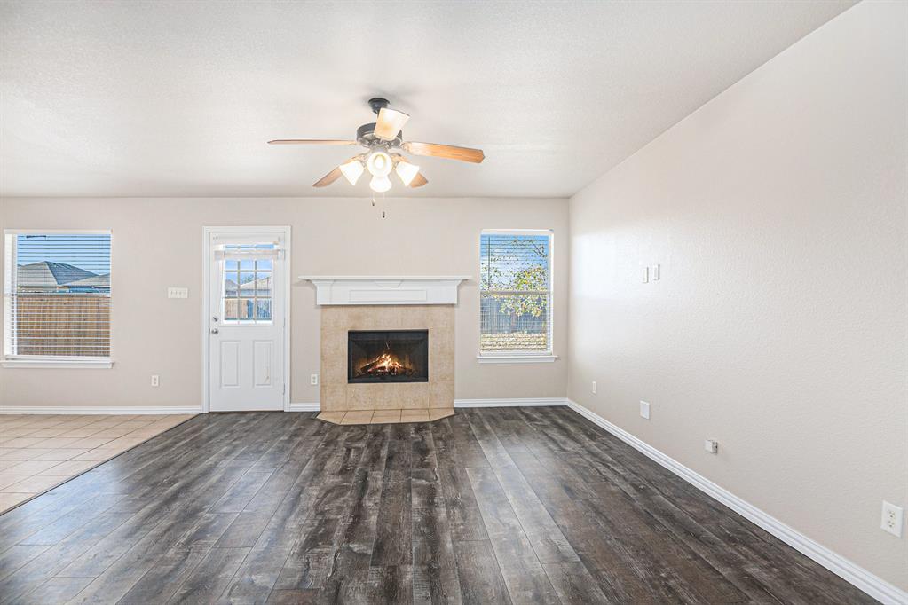 8313 Water Buck Run Fort Worth, TX 76179 - Photo 6 of 25 wooden floor in an empty room with a window