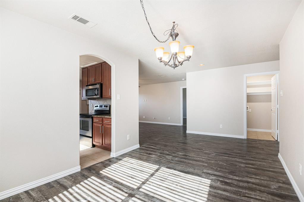 8313 Water Buck Run Fort Worth, TX 76179 - Photo 9 of 25 a view of a room with wooden floor and staircase