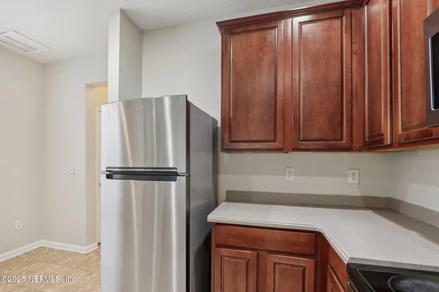 a kitchen with a refrigerator and cabinets