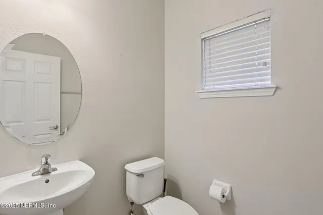 a white toilet sitting next to a bathroom sink