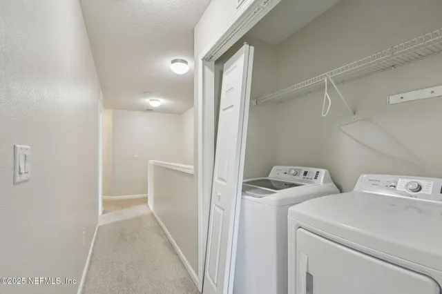 a view of storage and utility room with washer and dryer