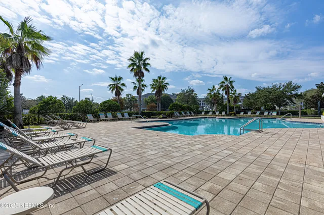 a front view of house with yard seating and green space