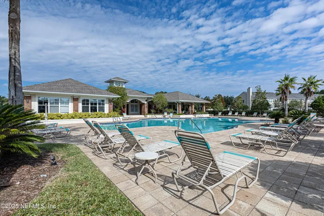 a view of a chairs and table in the back yard