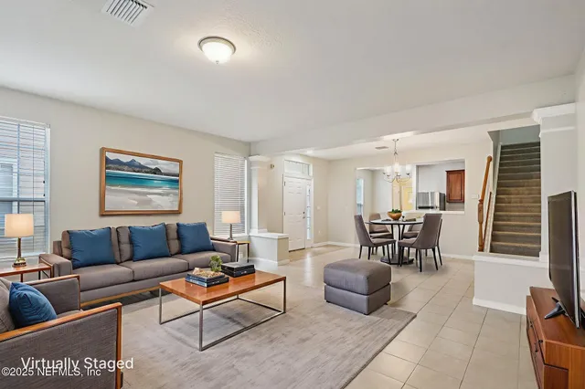 a living room with furniture a rug and a window