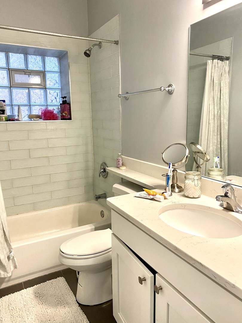 Undisclosed Address Chicago, IL 60657 - Photo 3 of 12 a bathroom with a sink toilet and shower