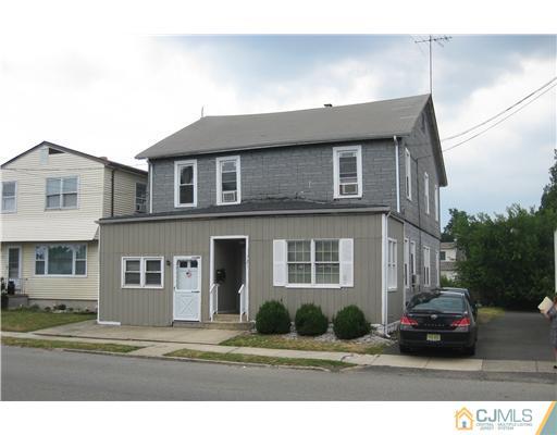 a black and white building with a view of car parked