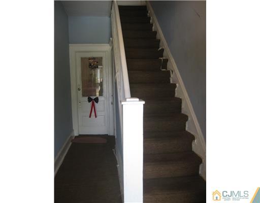 721 Lincoln Boulevard Middlesex, NJ 08846 - Photo 10 of 10 a view of a hallway with white walls and stairs