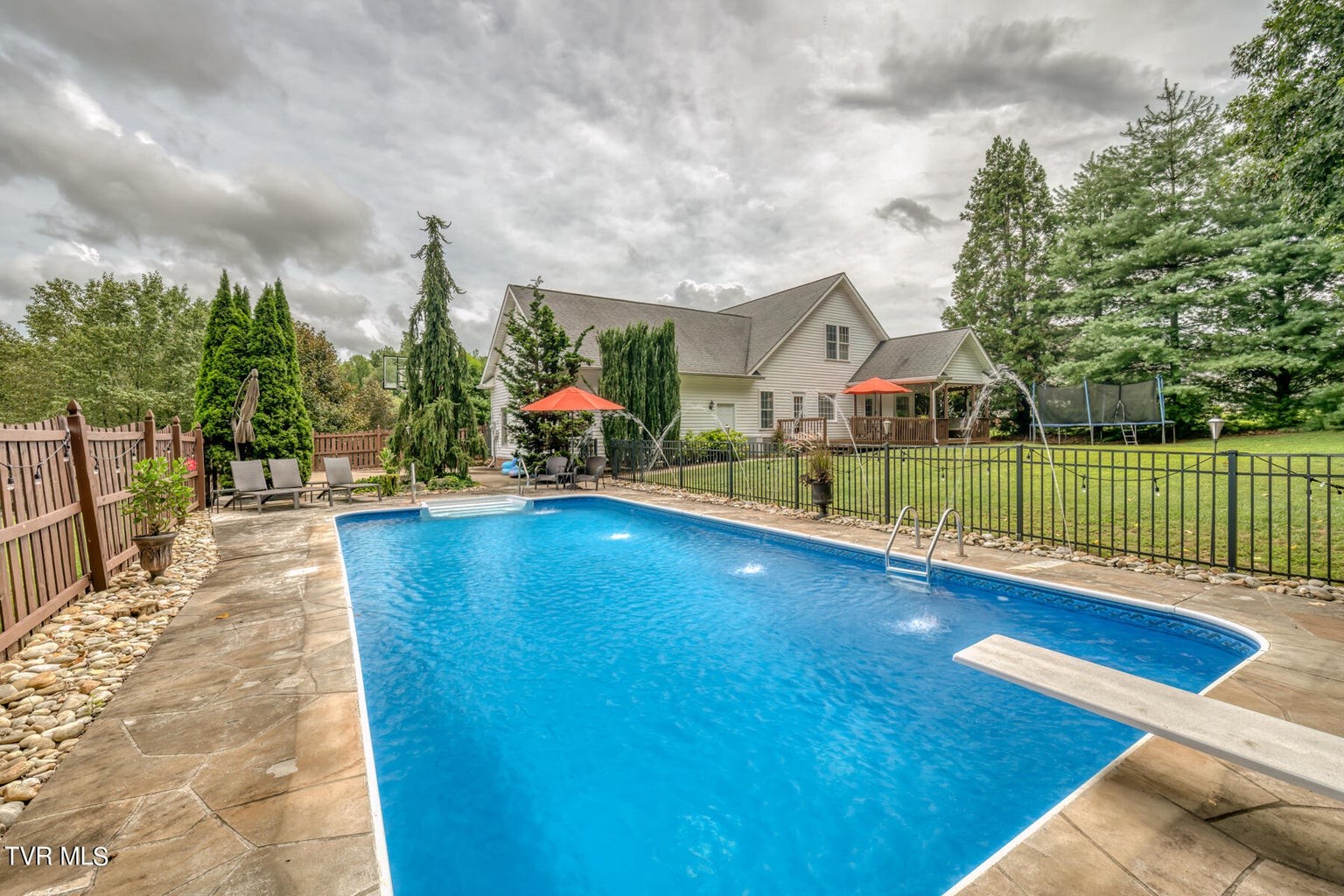 1828 Weaver Branch Road Piney Flats, TN 37686 - Photo 13 of 54 a view of swimming pool with lawn chairs and wooden fence