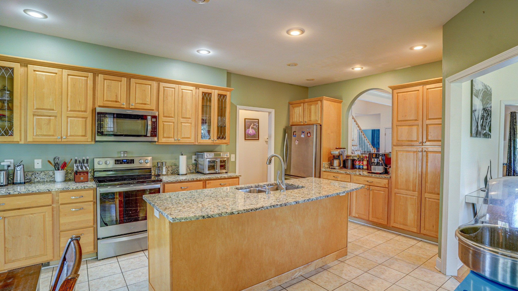 1828 Weaver Branch Road Piney Flats, TN 37686 - Photo 29 of 54 a kitchen with stainless steel appliances granite countertop a stove a sink a refrigerator and cabinets