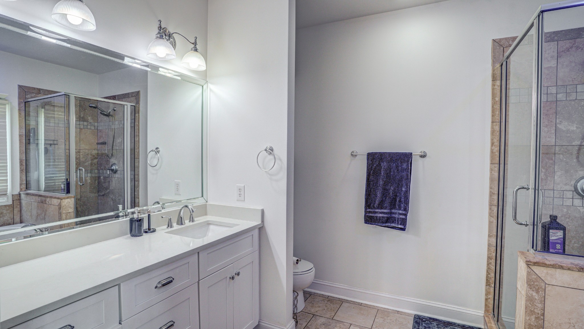 1828 Weaver Branch Road Piney Flats, TN 37686 - Photo 43 of 54 a bathroom with a double vanity sink a toilet and a large mirror