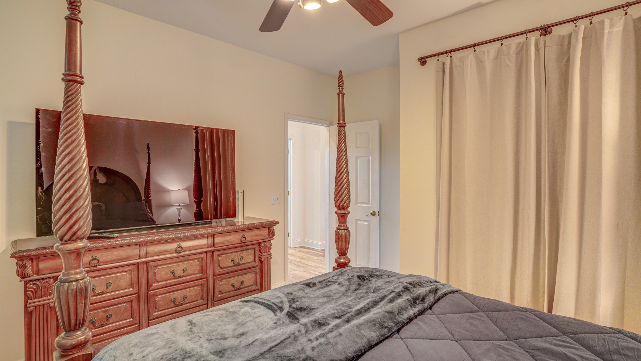1828 Weaver Branch Road Piney Flats, TN 37686 - Photo 50 of 54 a bedroom with a bed and a flat tv screen on dresser