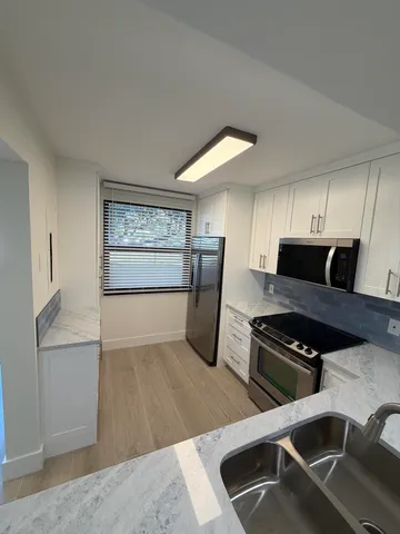 a kitchen that has a sink and a stove