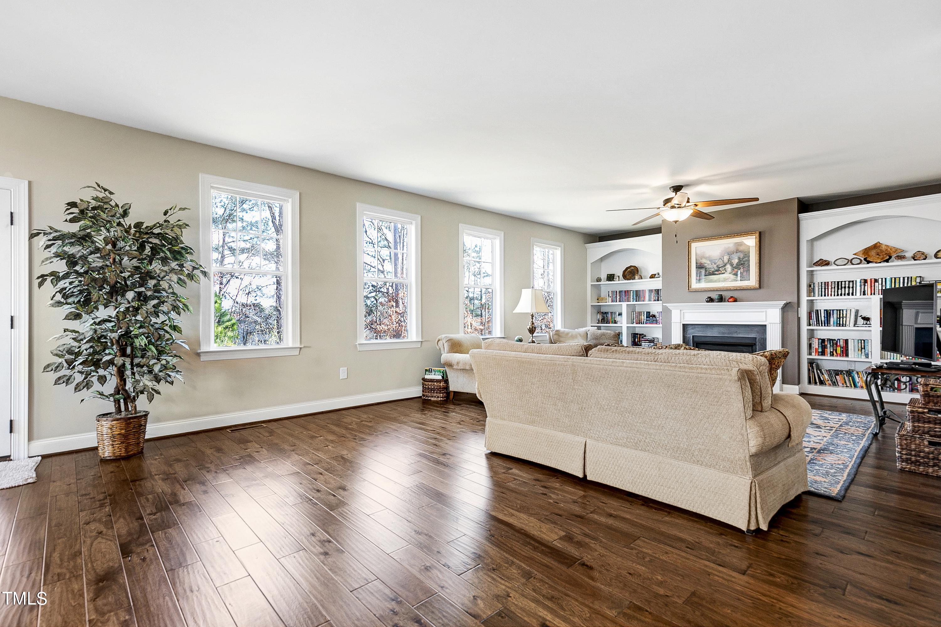 8533 Hurst Drive Raleigh, NC 27603 - Photo 14 of 43 a living room with furniture and a large window with wooden floor