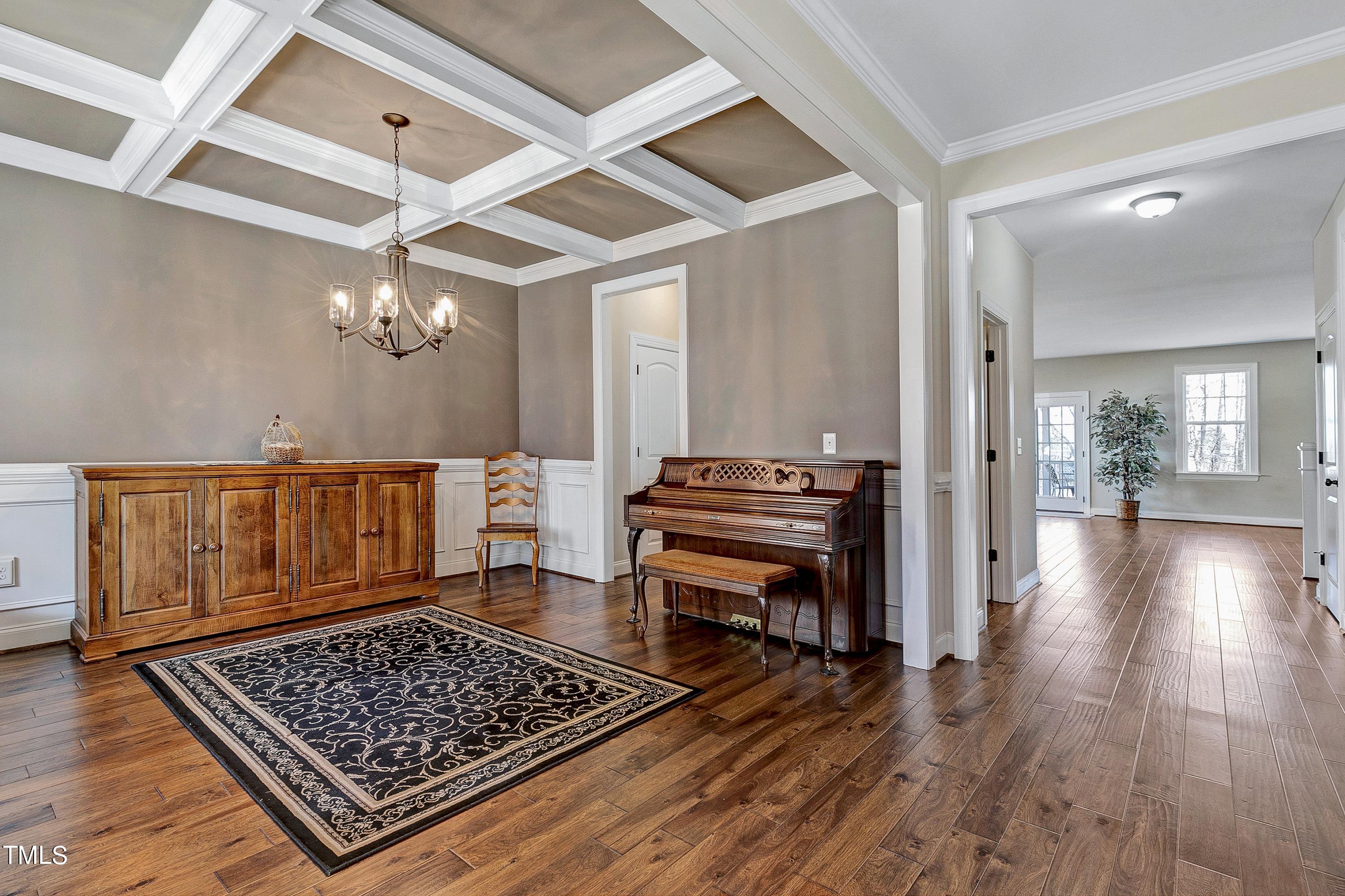 8533 Hurst Drive Raleigh, NC 27603 - Photo 38 of 43 a view of room with wooden floor and piano table