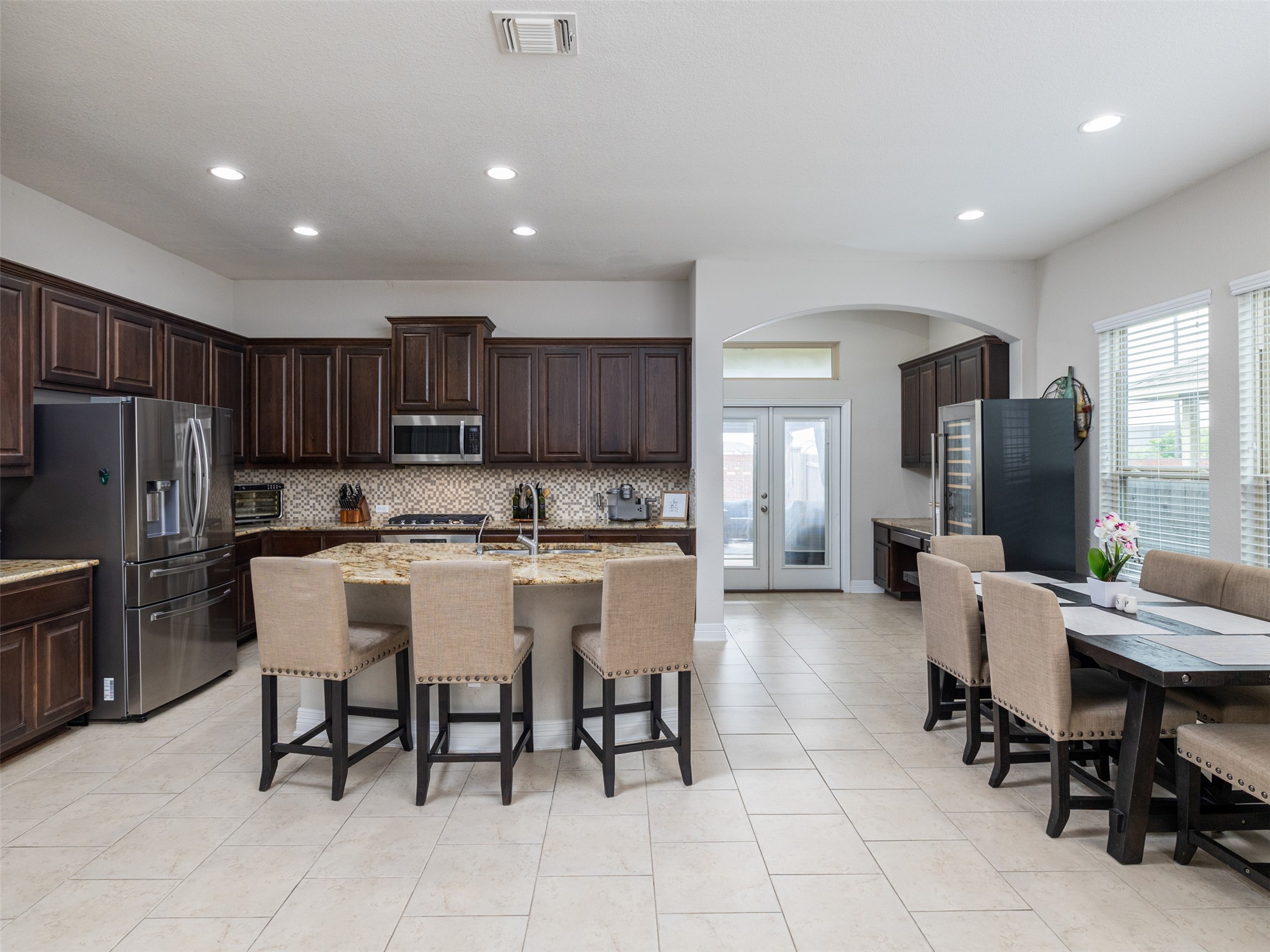 717 Blue Agave Lane Georgetown, TX 78626 - Photo 8 of 28 a large kitchen with kitchen island a dining table and chairs