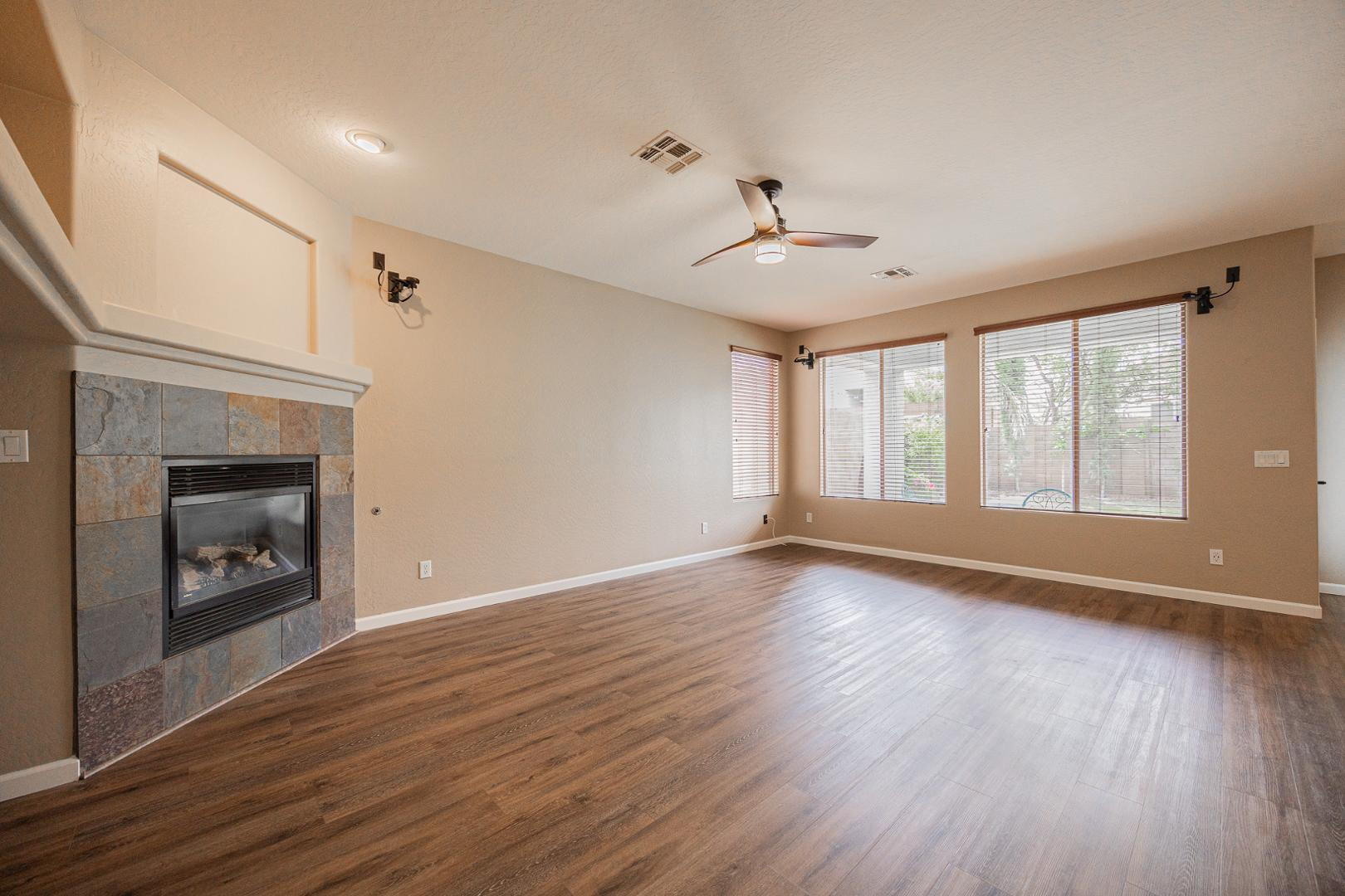 6539 West Jomax Road Phoenix, AZ 85083 - Photo 4 of 39 a view of an empty room with window and wooden floor