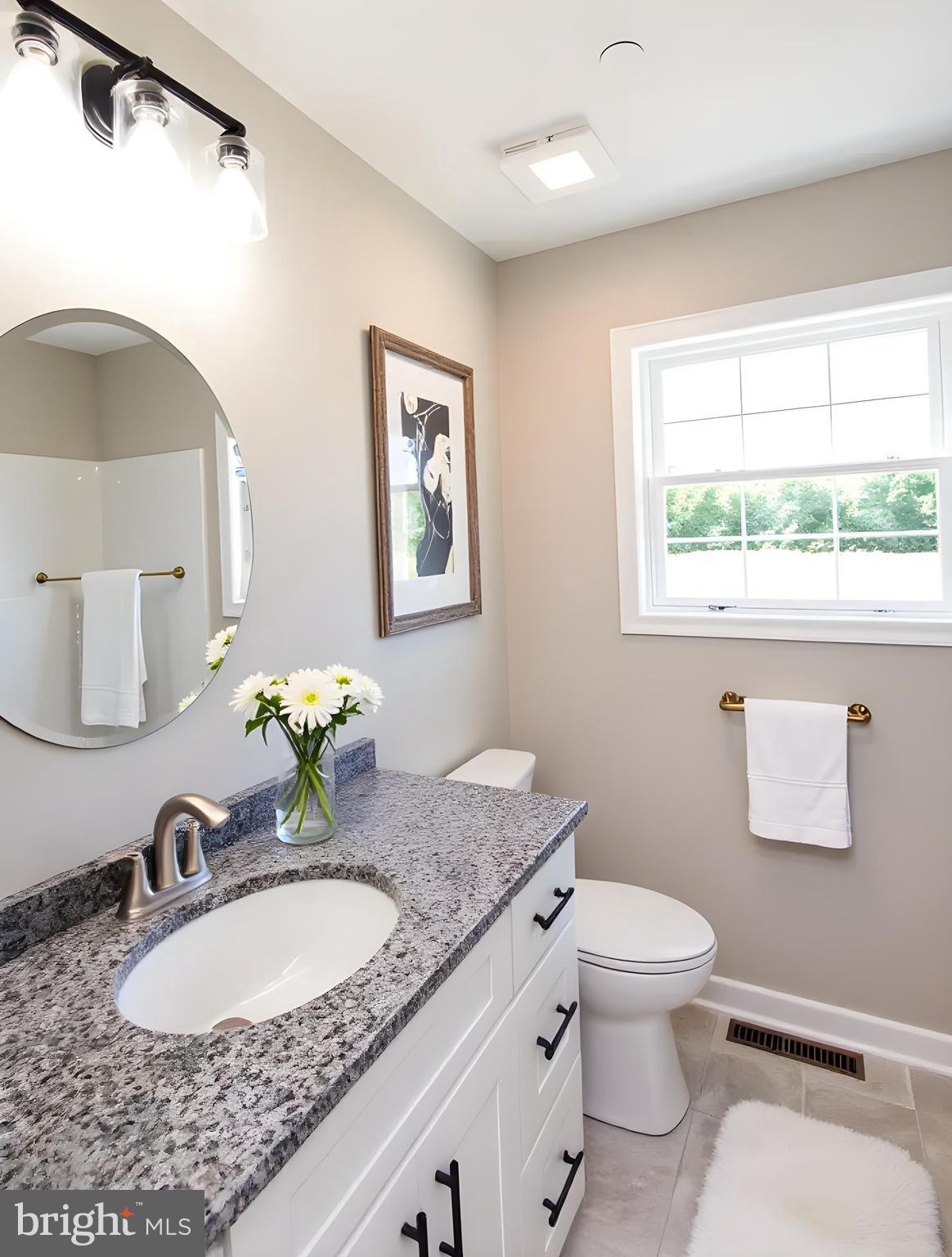 Wrights Rest Road Hurlock, MD 21643 - Photo 9 of 22 a bathroom with a granite countertop sink mirror vanity and toilet